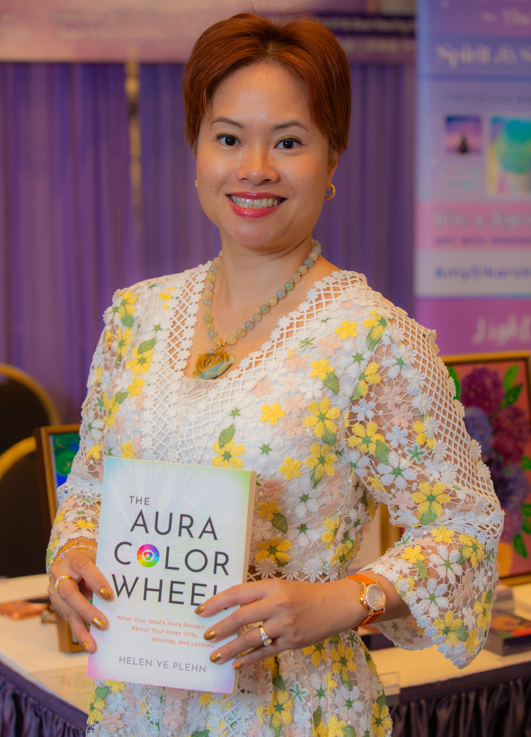 Helen Ye Plehn holding her book, The Aura Color Wheel